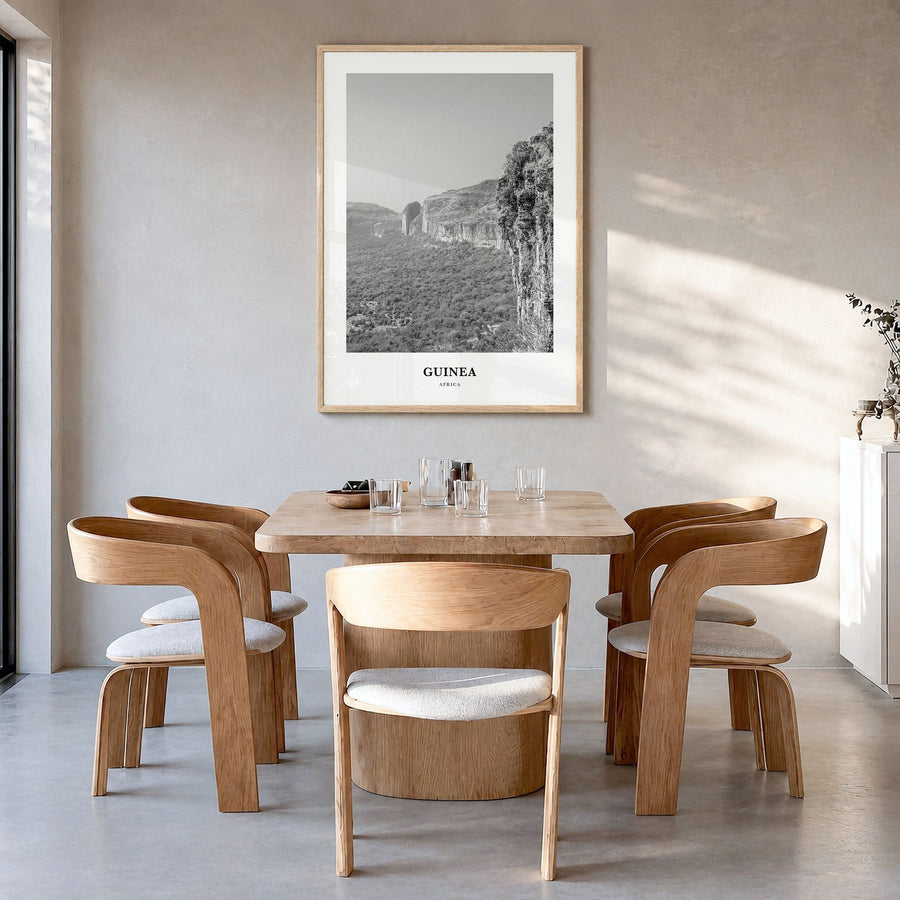 Guinea Classic Poster in a natural wood frame, hanging in a dining room