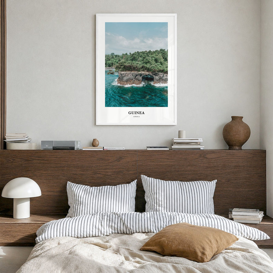 Guinea Classic No 1 Poster in a white wood frame, hanging in a bedroom