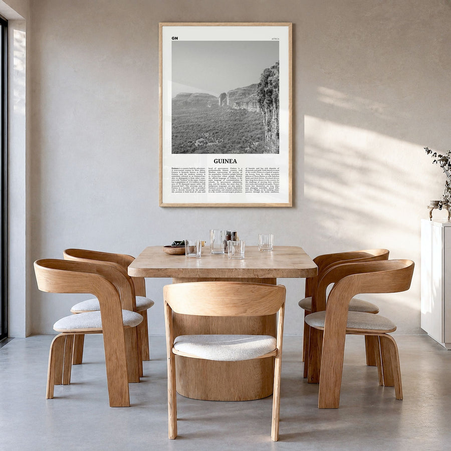 Guinea Newspaper Poster in a natural wood frame, hanging in a dining room