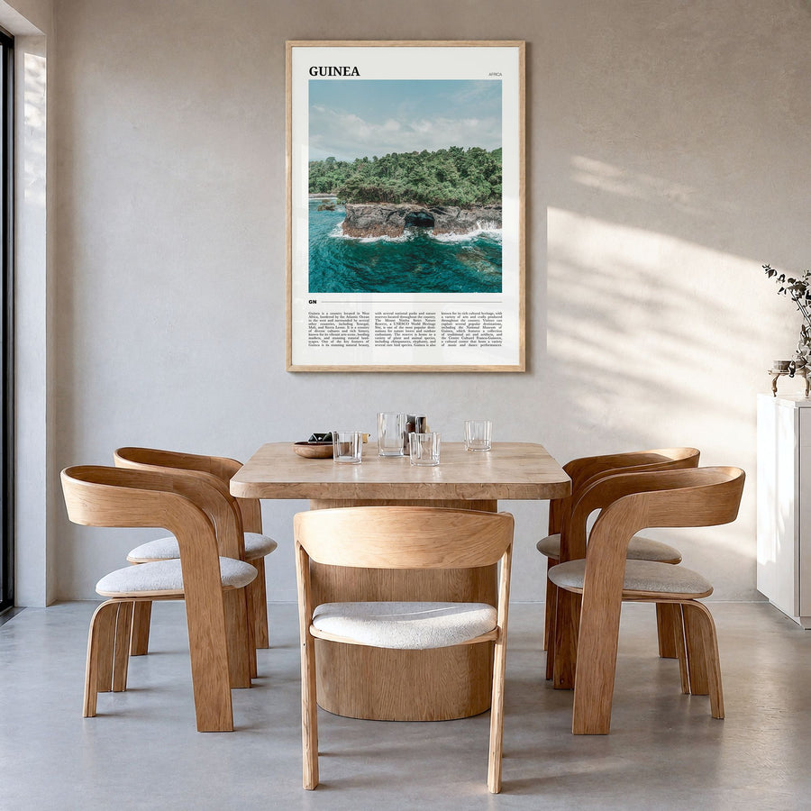 Guinea Travel No 1 Poster in a natural wood frame, hanging in a dining room
