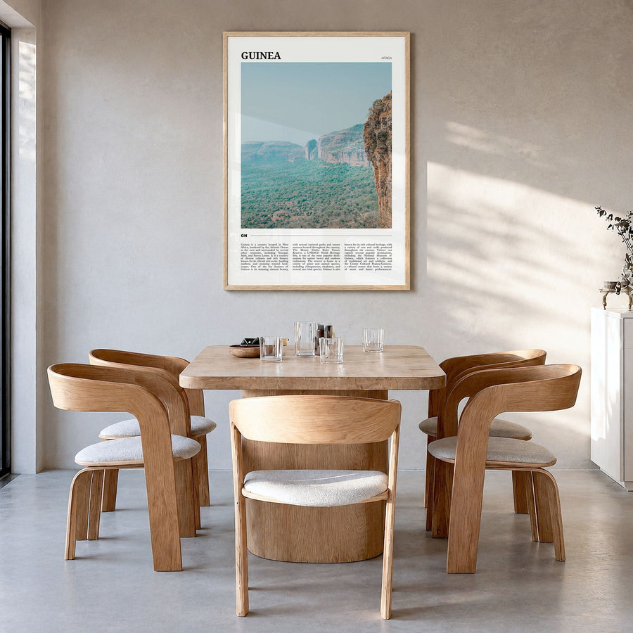 Guinea Travel No 2 Poster in a natural wood frame, hanging in a dining room
