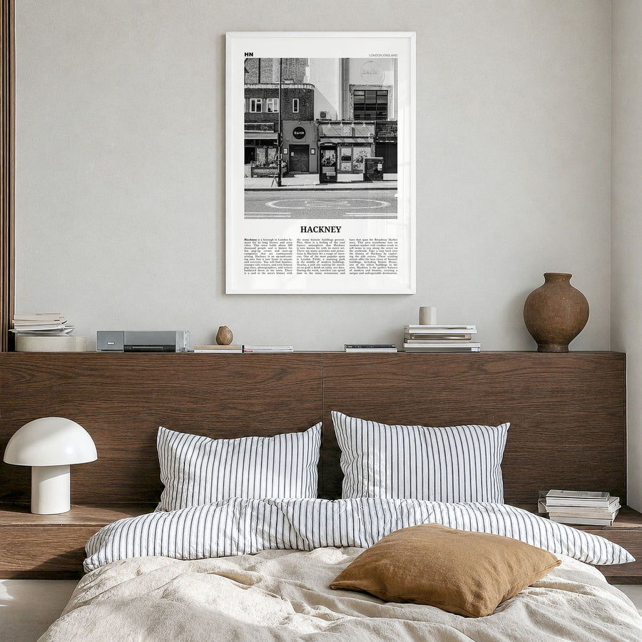 Hackney Newspaper Poster in a white wood frame, hanging in a bedroom