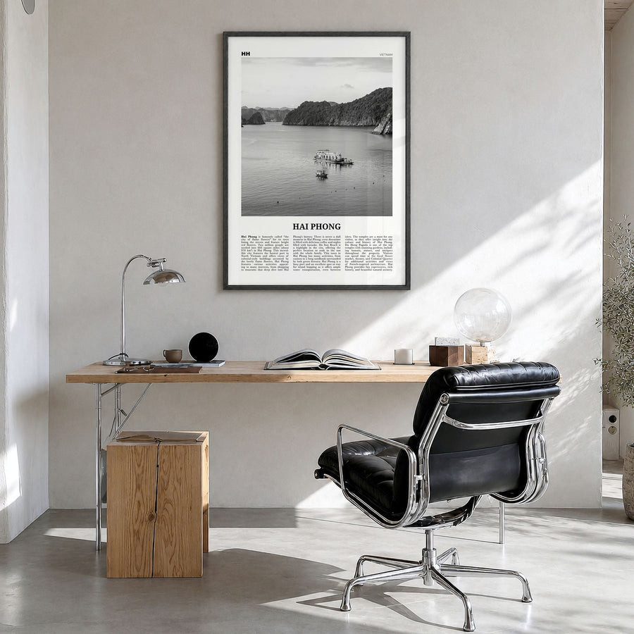 Hai Phong Newspaper Poster in a black wood frame, hanging in a bright home office