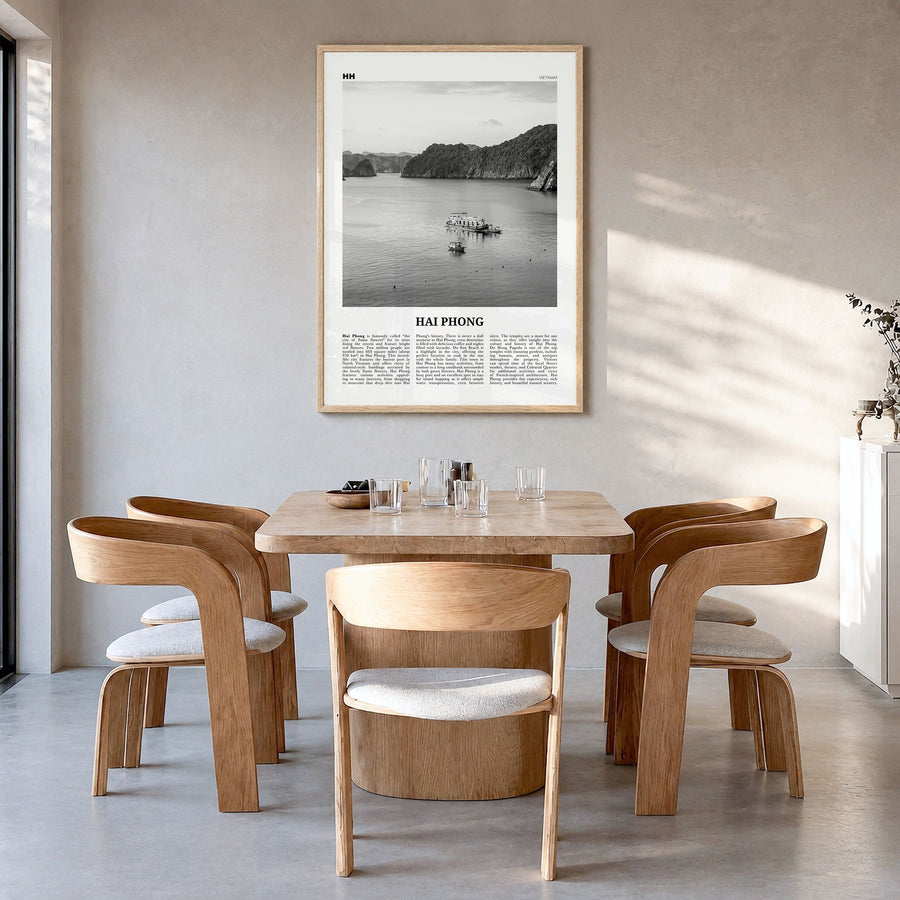 Hai Phong Newspaper Poster in a natural wood frame, hanging in a dining room