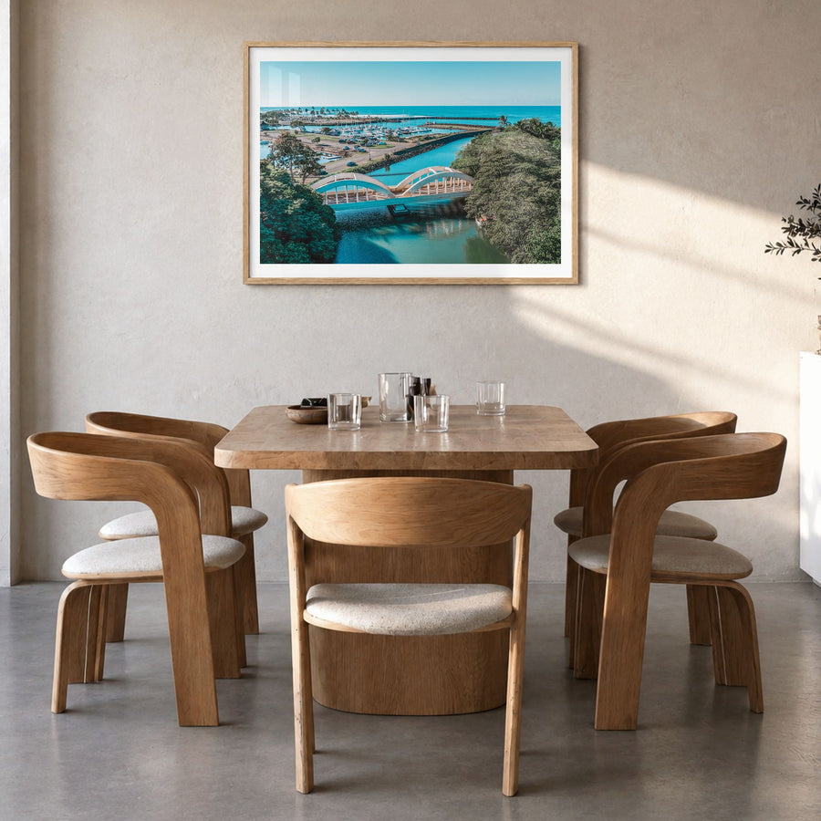 Haleiwa Photo Poster in a natural wood frame, hanging in a dining room, white border
