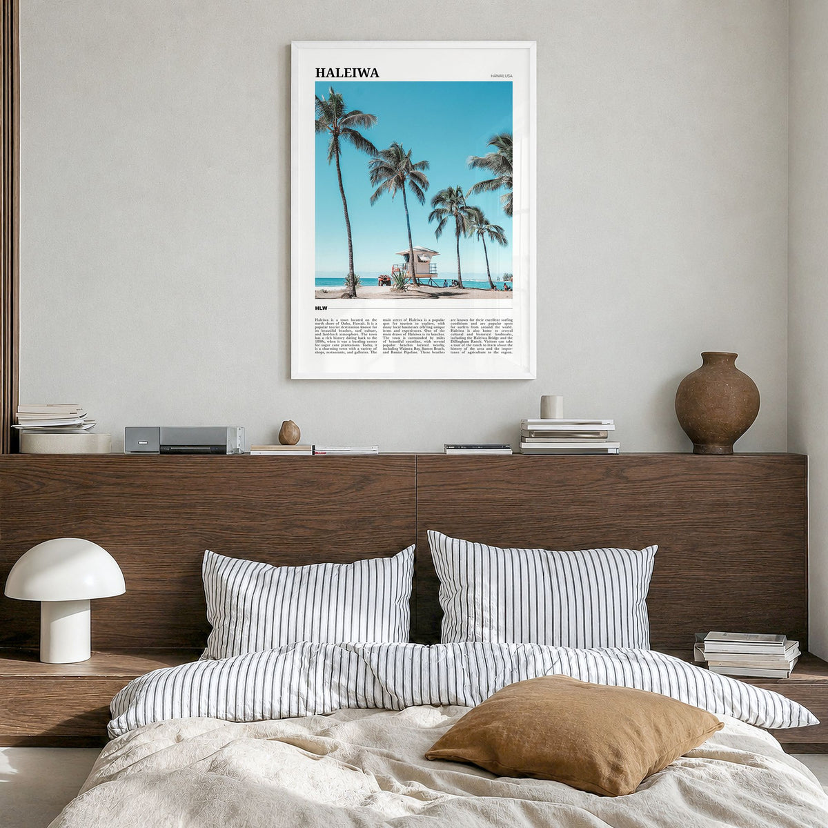 Haleiwa Travel Poster in a white wood frame, hanging in a bedroom