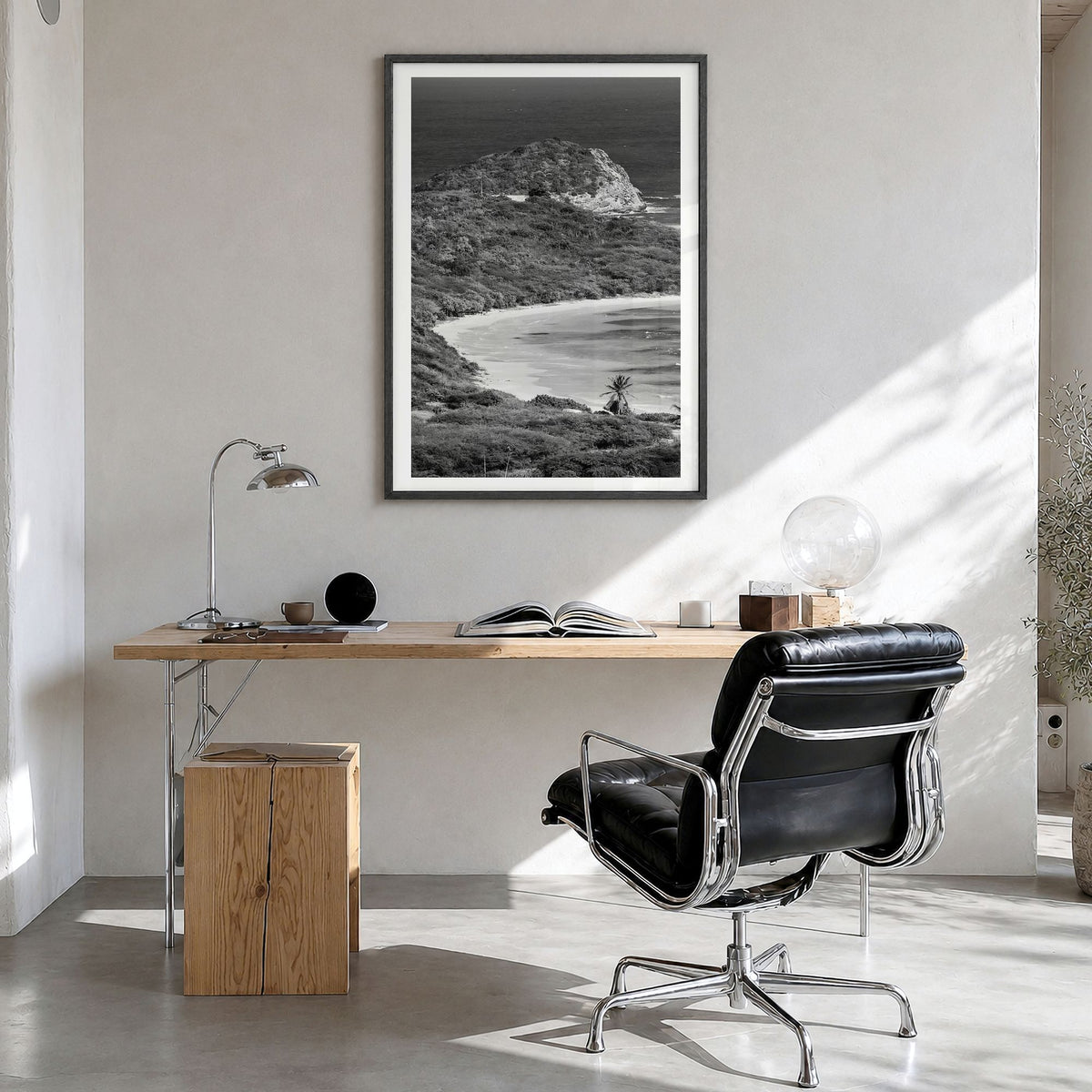 Half Moon Bay Photo Poster in a black wood frame, hanging in a bright home office, white border