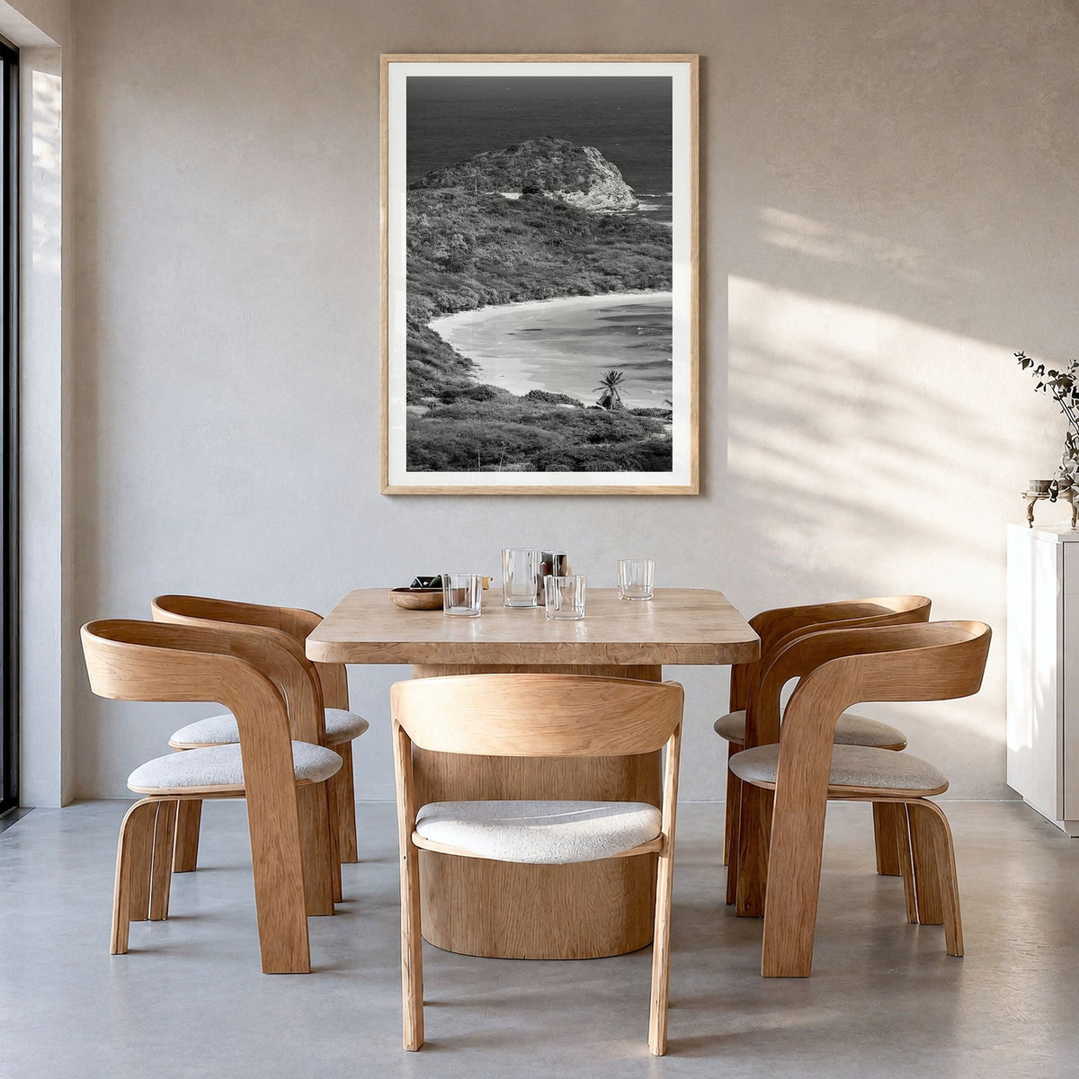 Half Moon Bay Photo Poster in a natural wood frame, hanging in a dining room, white border