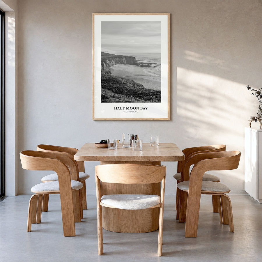Half Moon Bay Classic Poster in a natural wood frame, hanging in a dining room
