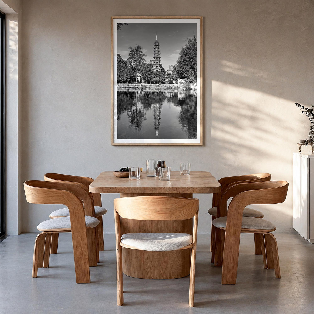 Hanoi black & white photo poster of Vietnam – vertical wall art in natural wood frame with white border, hanging on wall