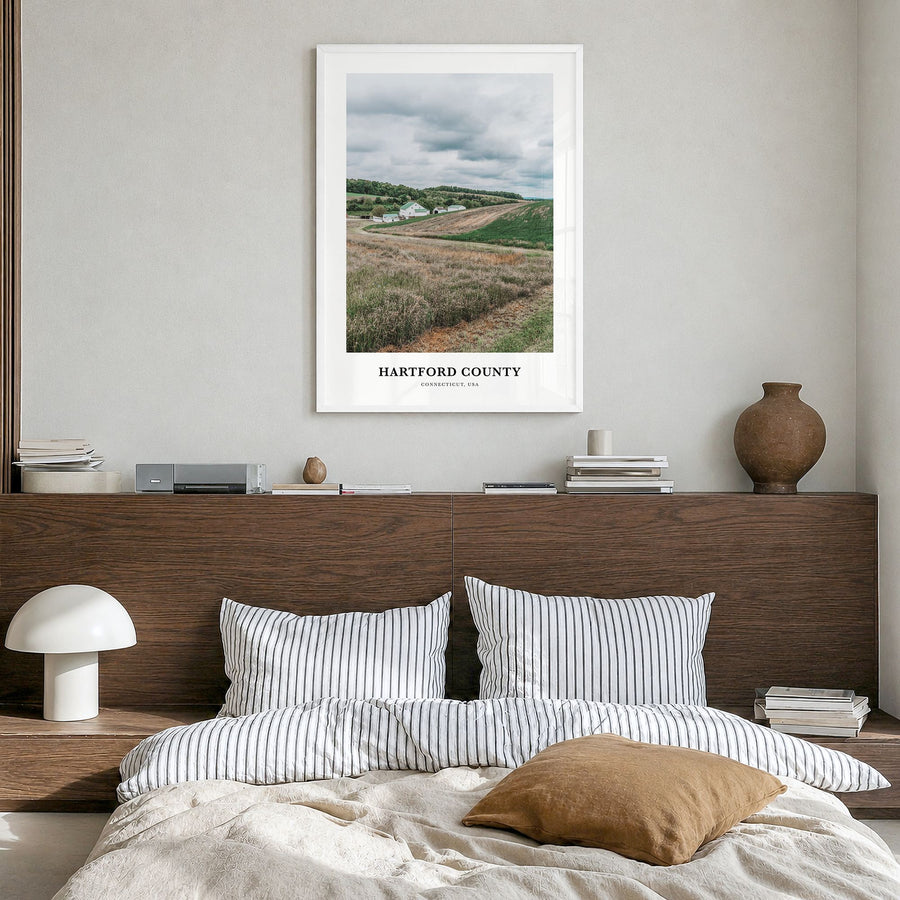 Hartford County Classic Poster in a white wood frame, hanging in a bedroom