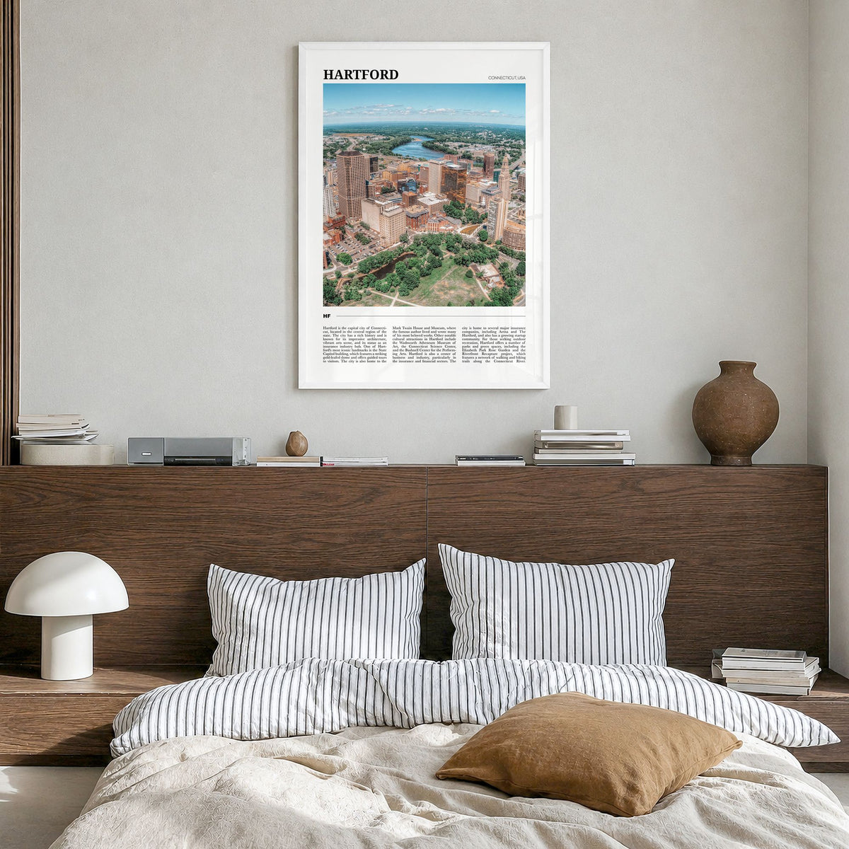 Hartford Travel No 1 Poster in a white wood frame, hanging in a bedroom