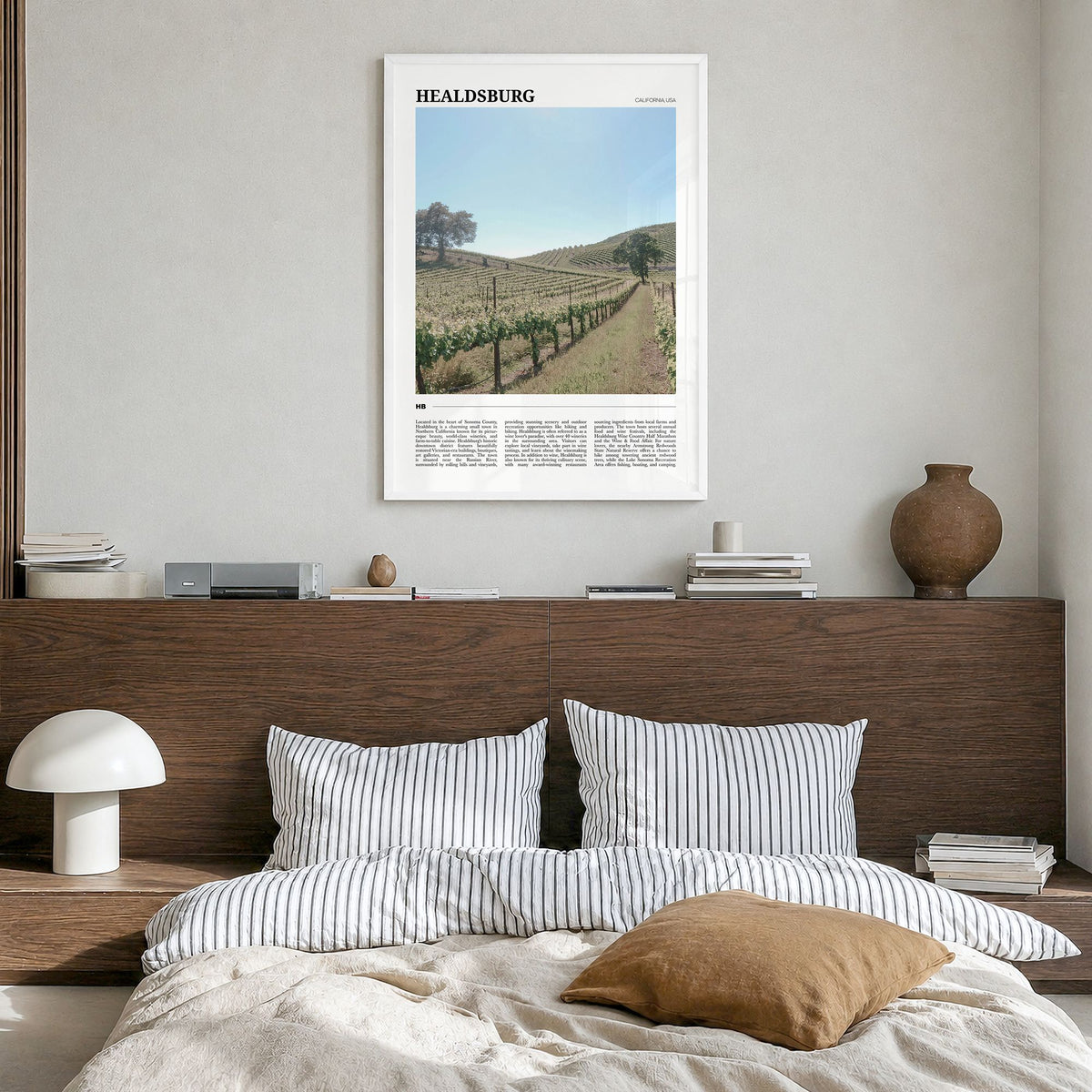 Healdsburg Travel Poster in a white wood frame, hanging in a bedroom