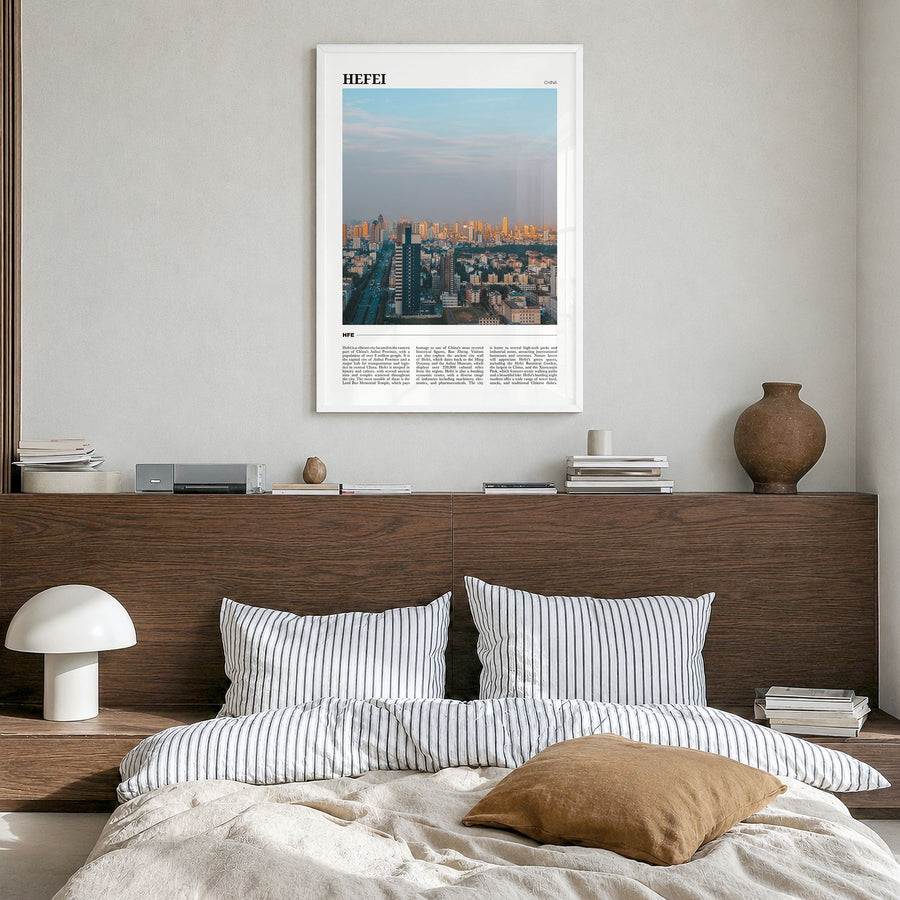 Hefei Travel Poster in a white wood frame, hanging in a bedroom