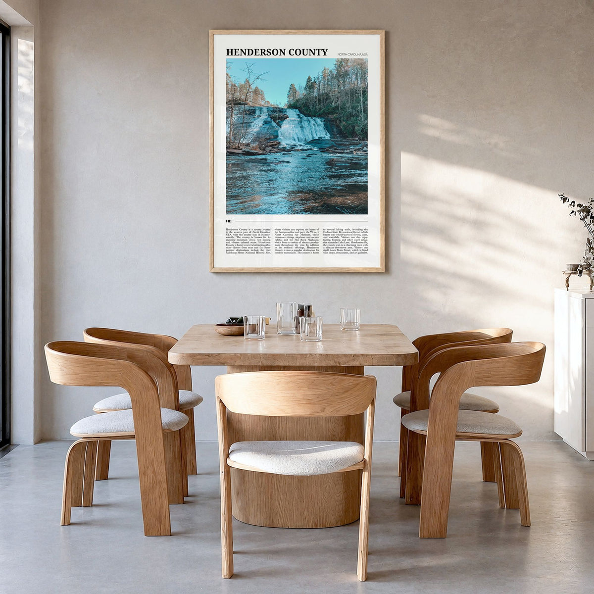 Henderson County, North Carolina Travel Poster in a natural wood frame, hanging in a dining room