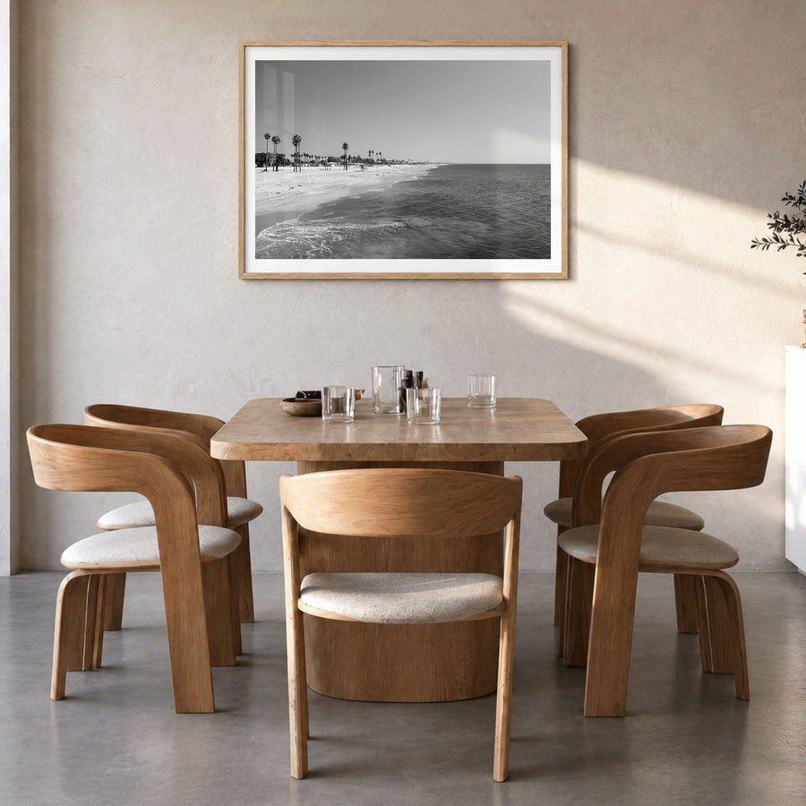 Hermosa Beach Photo Poster in a natural wood frame, hanging in a dining room, white border
