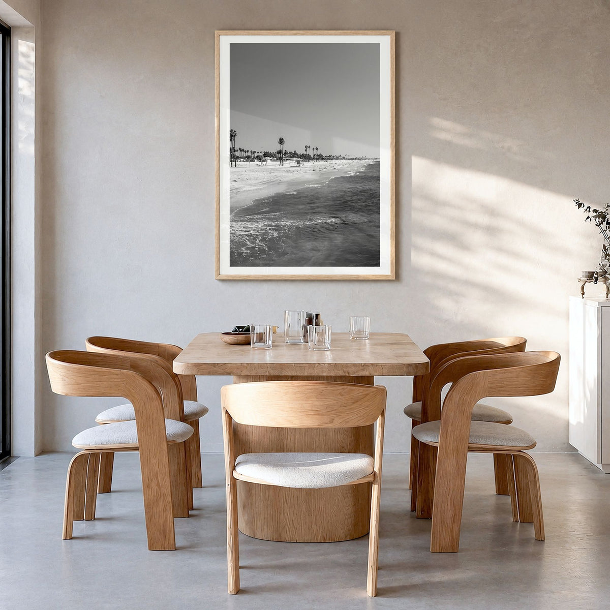 Hermosa Beach Photo Poster in a natural wood frame, hanging in a dining room, white border