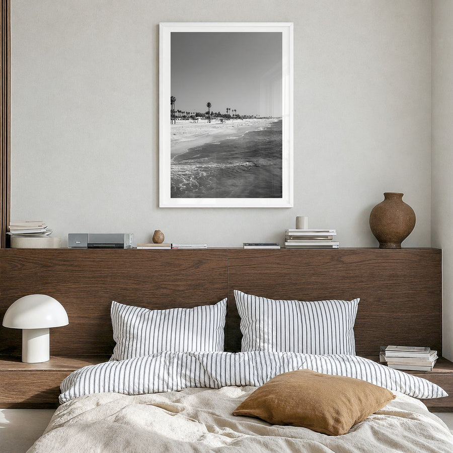 Hermosa Beach Photo Poster in a white wood frame, hanging in a bedroom, white border