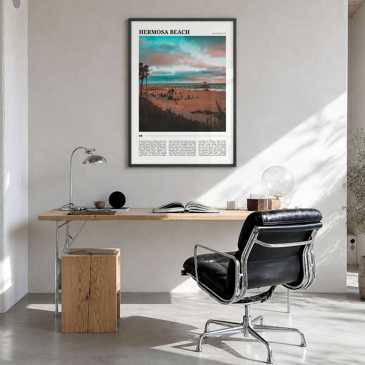 Hermosa Beach Travel Poster in a black wood frame, hanging in a bright home office