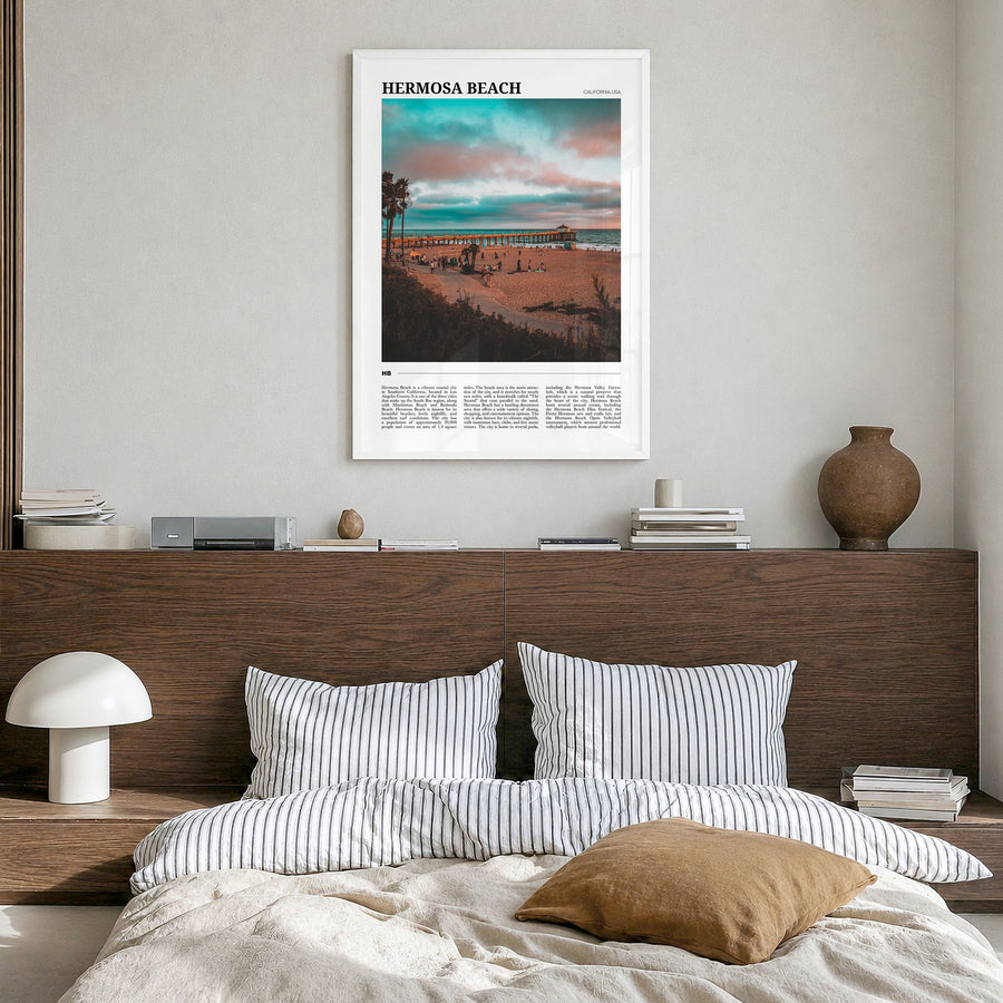 Hermosa Beach Travel Poster in a white wood frame, hanging in a bedroom