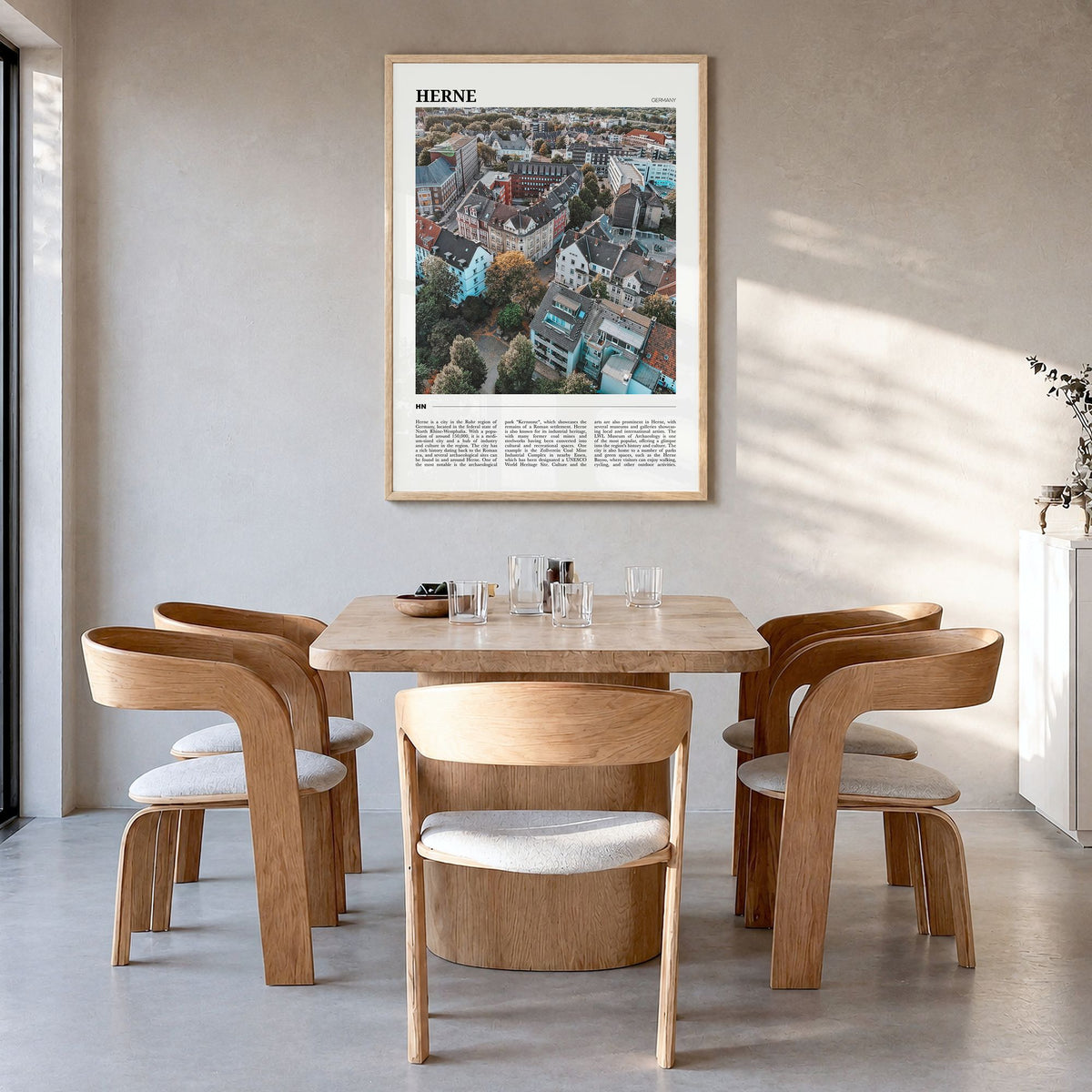 Herne Travel Poster in a natural wood frame, hanging in a dining room