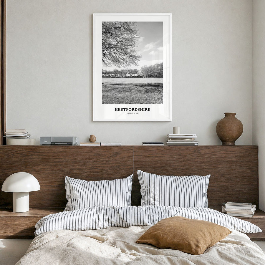 Hertfordshire Classic Poster in a white wood frame, hanging in a bedroom