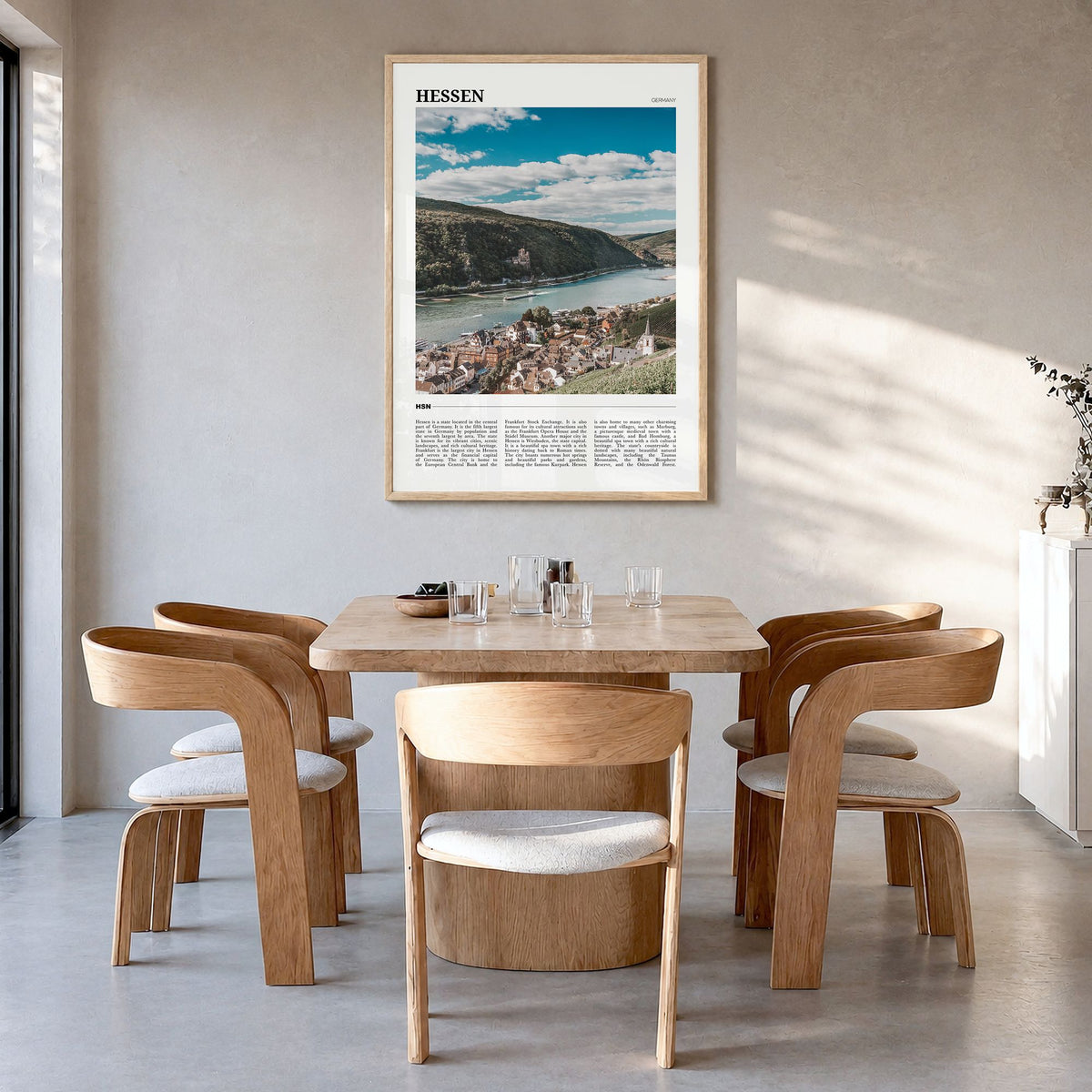 Hesse Travel Poster in a natural wood frame, hanging in a dining room