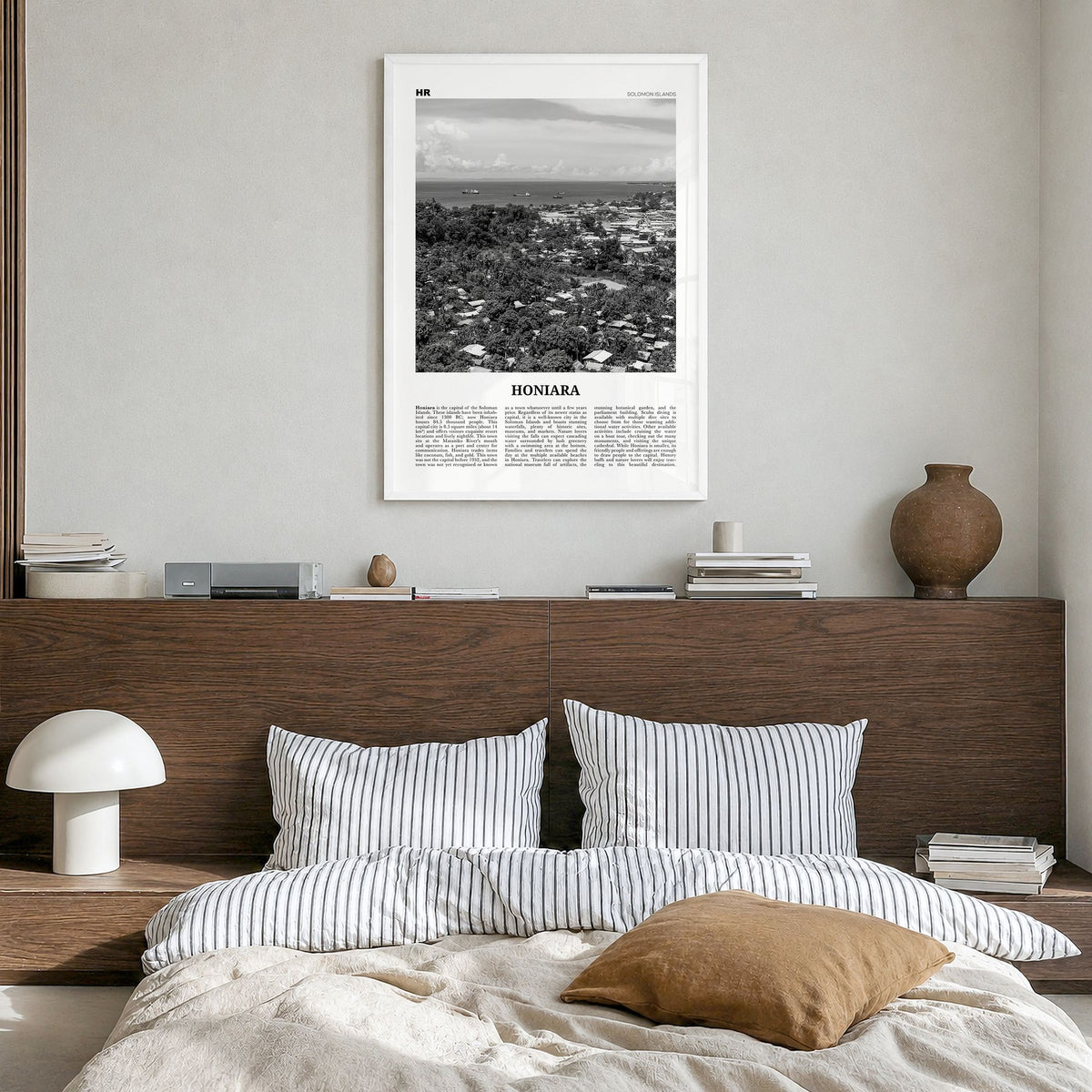 Honiara Newspaper Poster in a white wood frame, hanging in a bedroom