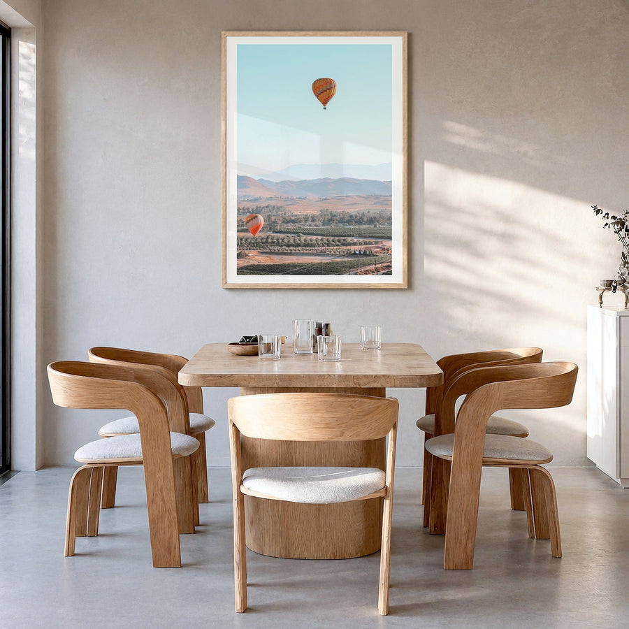 Hot Air Balloon Photo No 2 Poster in a natural wood frame, hanging in a dining room, white border