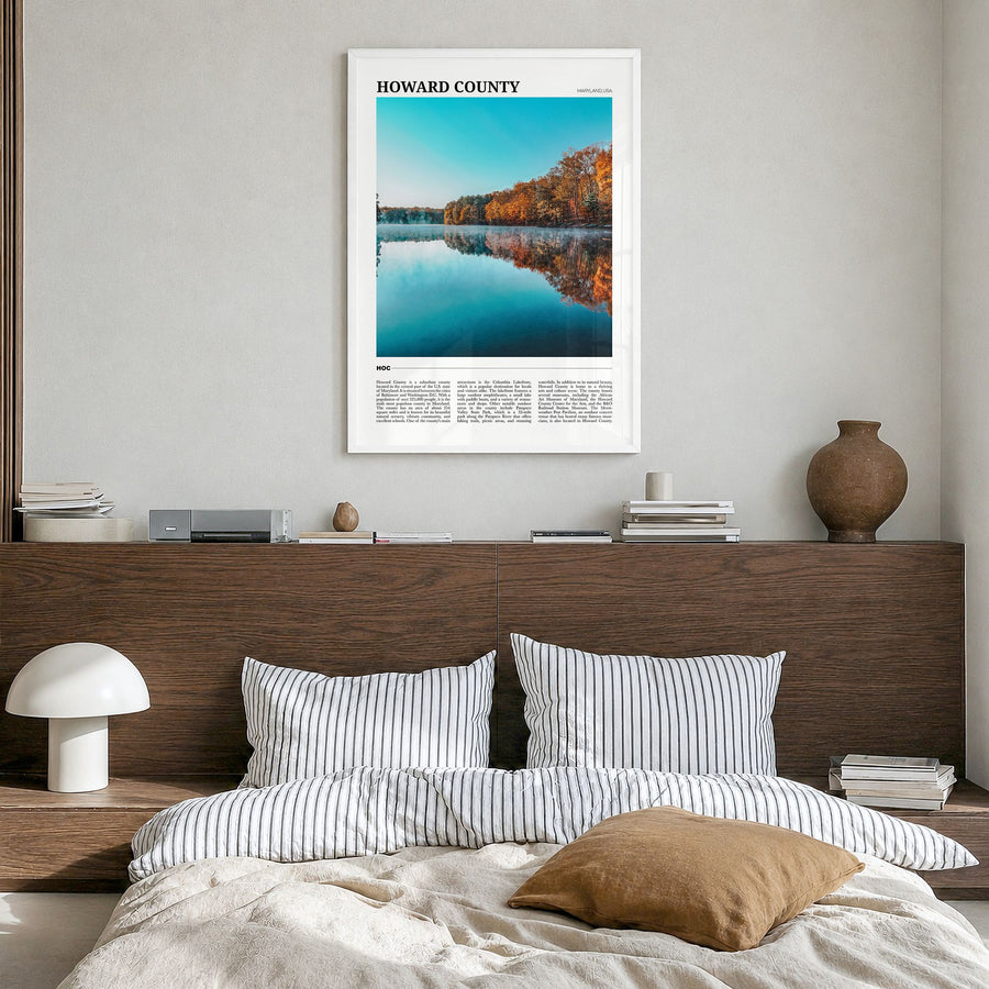 Howard County Travel Poster in a white wood frame, hanging in a bedroom