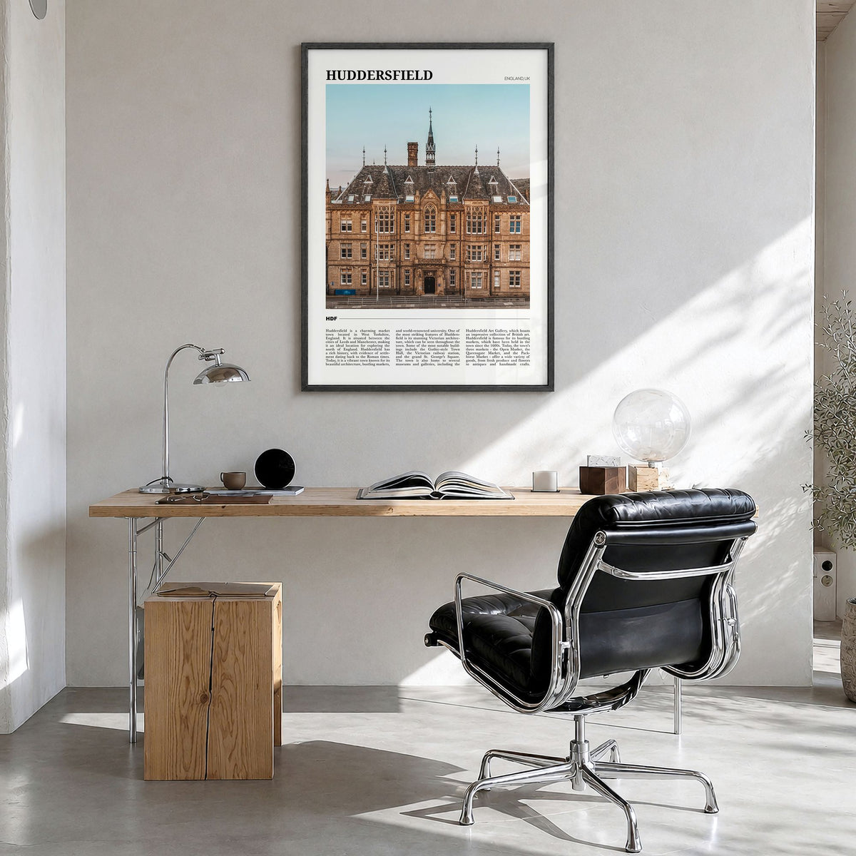 Huddersfield Travel Poster in a black wood frame, hanging in a bright home office