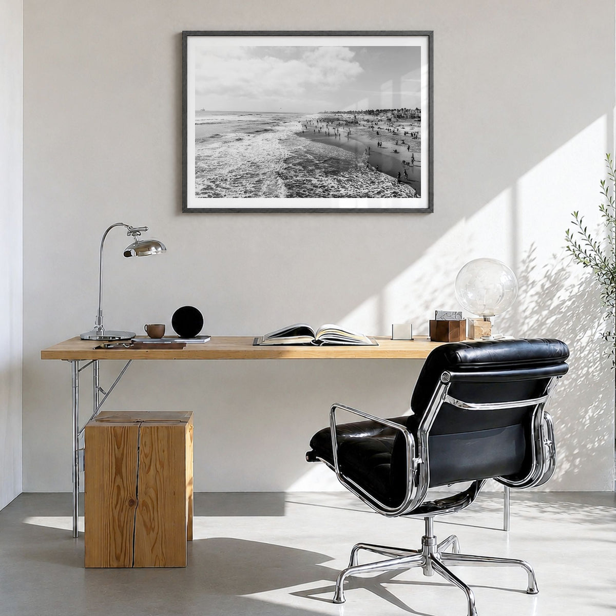 Huntington Beach Photo Poster in a black wood frame, hanging in a bright home office, white border