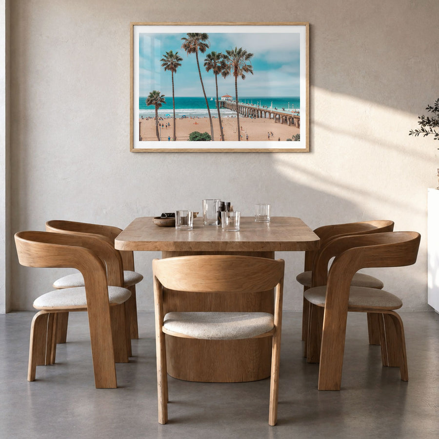 Huntington Beach Photo Poster in a natural wood frame, hanging in a dining room, white border