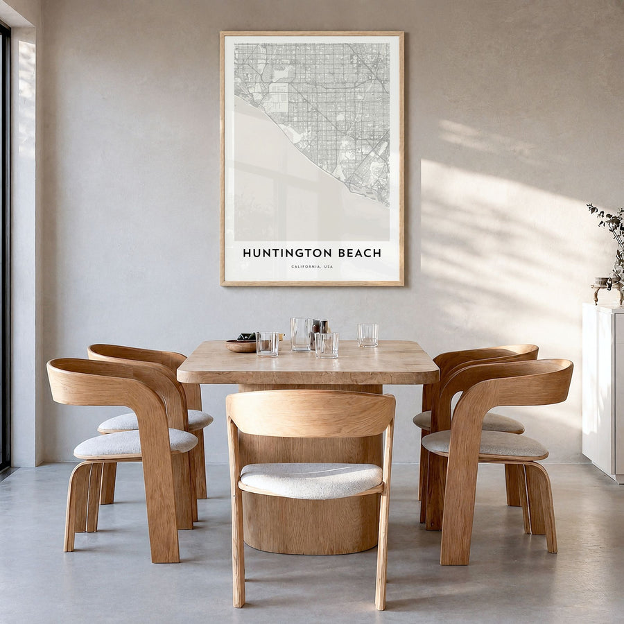 Huntington Beach Map Poster in a natural wood frame, hanging in a dining room