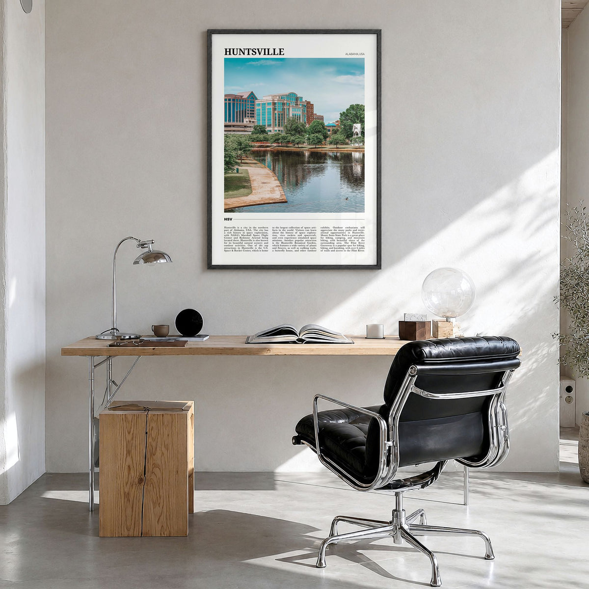 Huntsville Travel Poster in a black wood frame, hanging in a bright home office