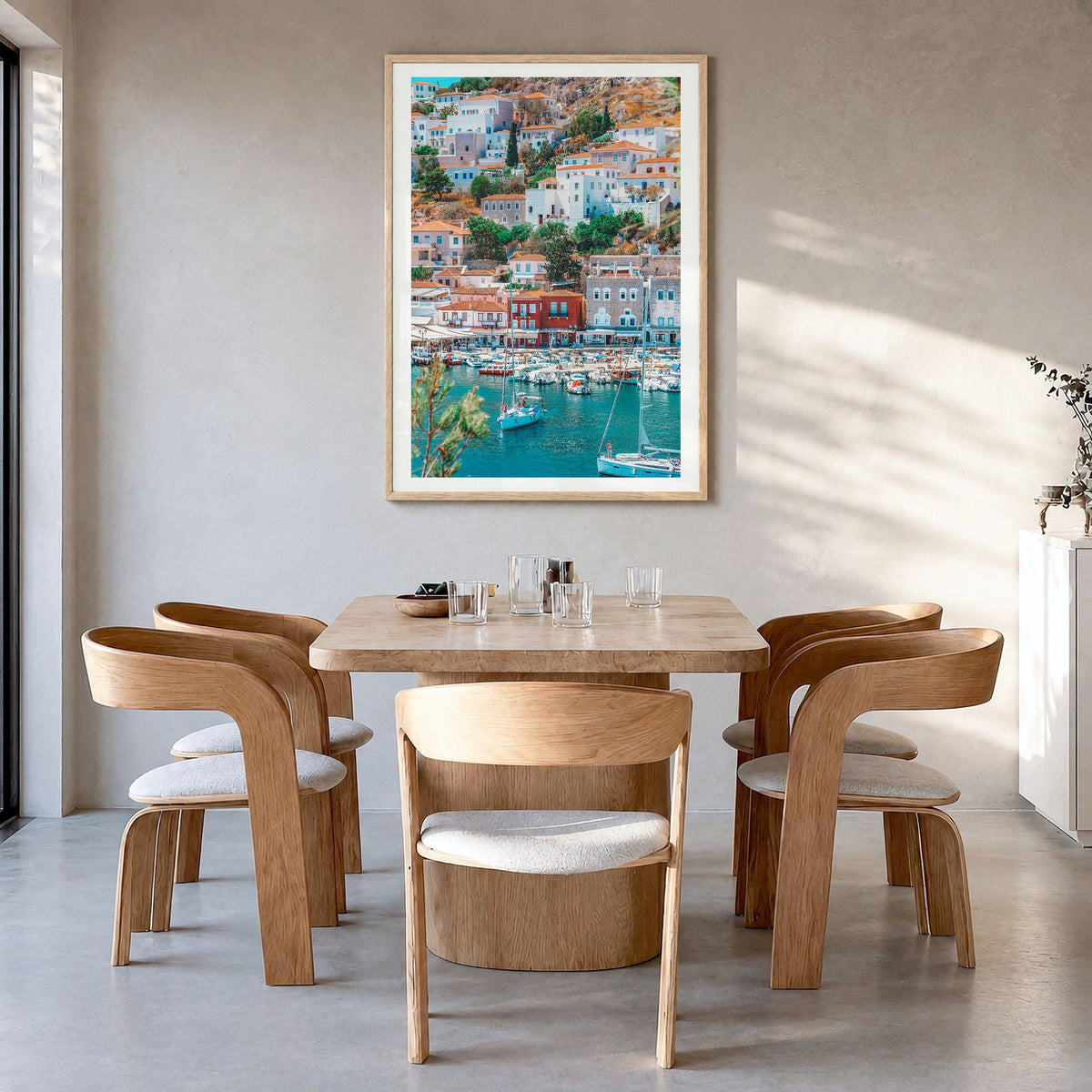 Hydra Photo Poster in a natural wood frame, hanging in a dining room, white border