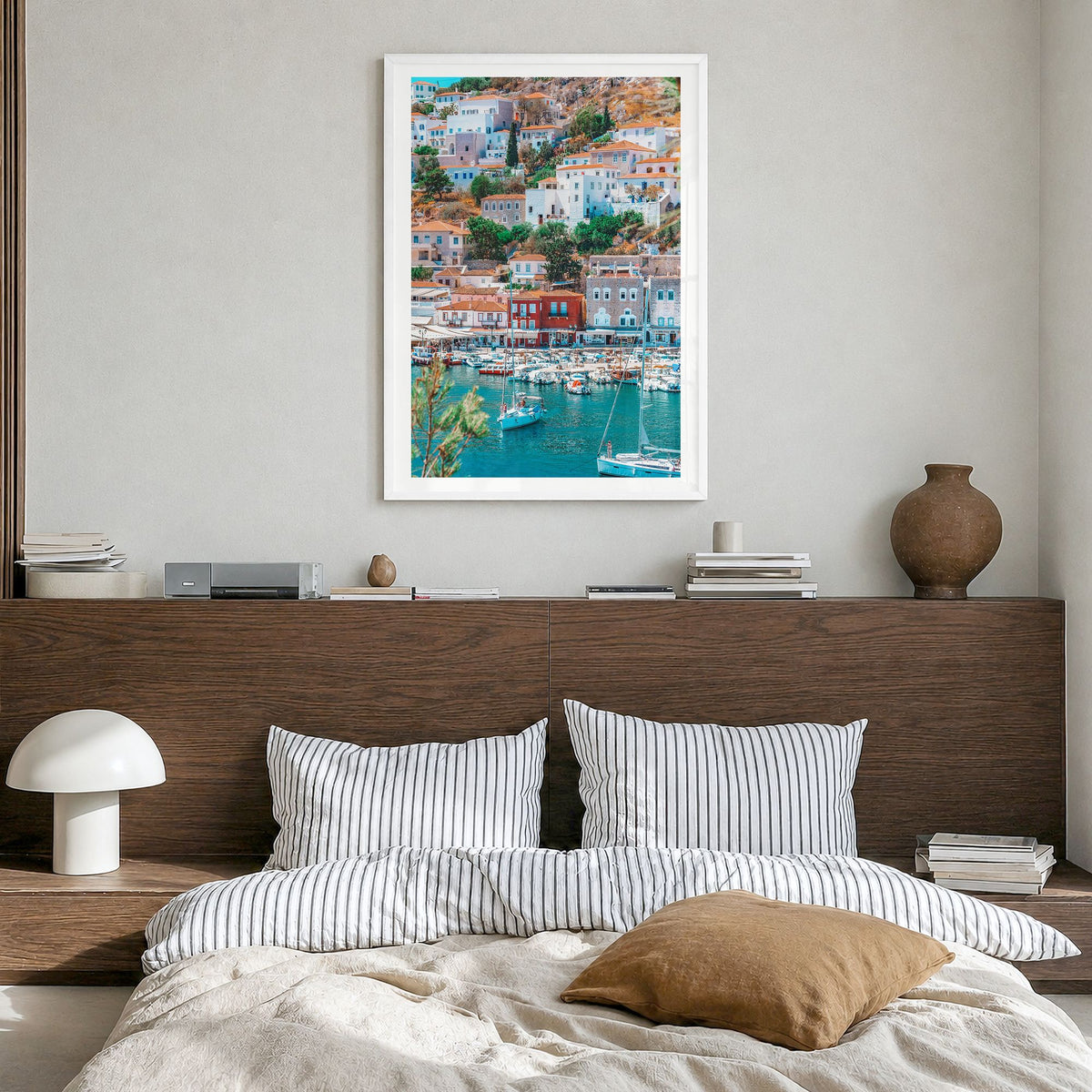 Hydra Photo Poster in a white wood frame, hanging in a bedroom, white border