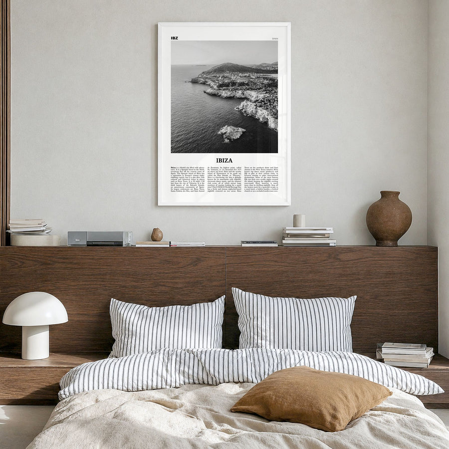 Ibiza Newspaper Poster in a white wood frame, hanging in a bedroom