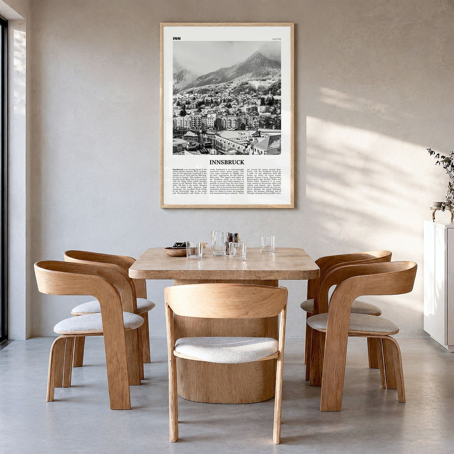 Innsbruck Newspaper Poster in a natural wood frame, hanging in a dining room