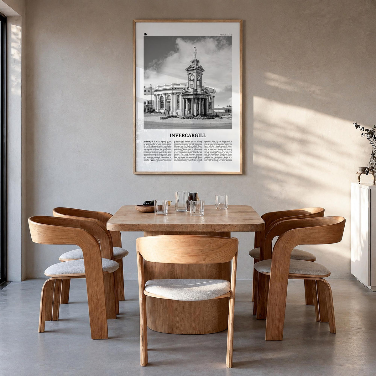 Invercargill black & white newspaper poster of New Zealand – vertical wall art in natural wood frame, hanging on wall