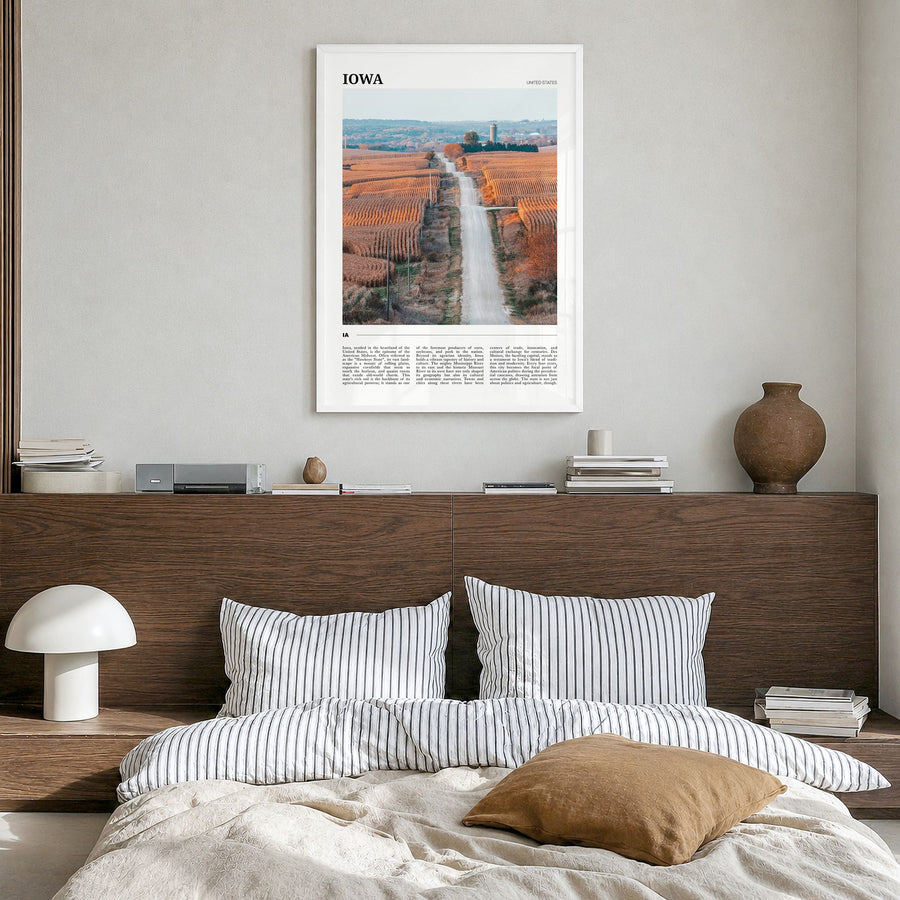 Iowa Travel Poster in a white wood frame, hanging in a bedroom