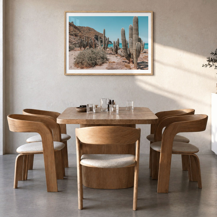 Isla Vista Photo Poster in a natural wood frame, hanging in a dining room, white border