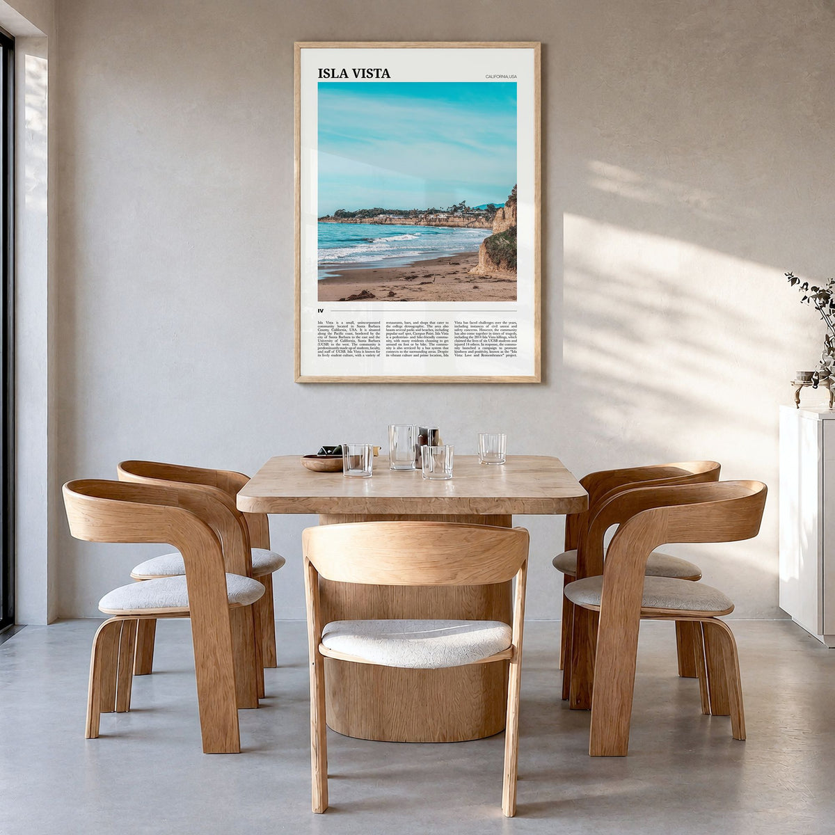 Isla Vista Travel Poster in a natural wood frame, hanging in a dining room