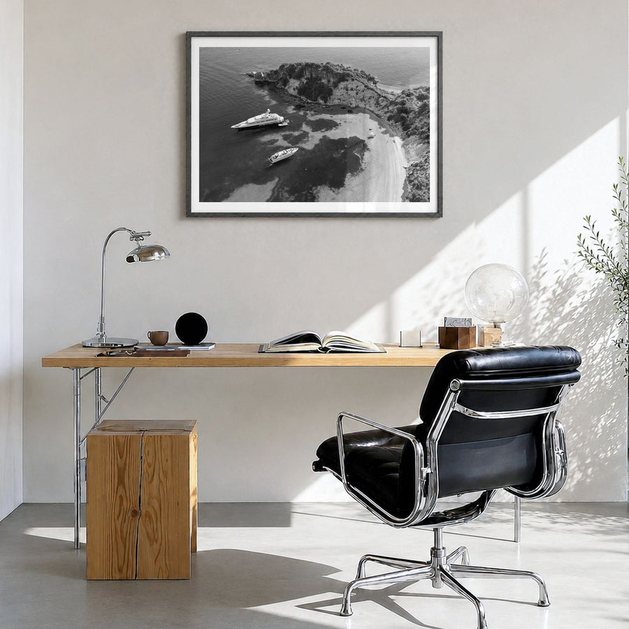 Ithaca Photo Poster in a black wood frame, hanging in a bright home office, white border
