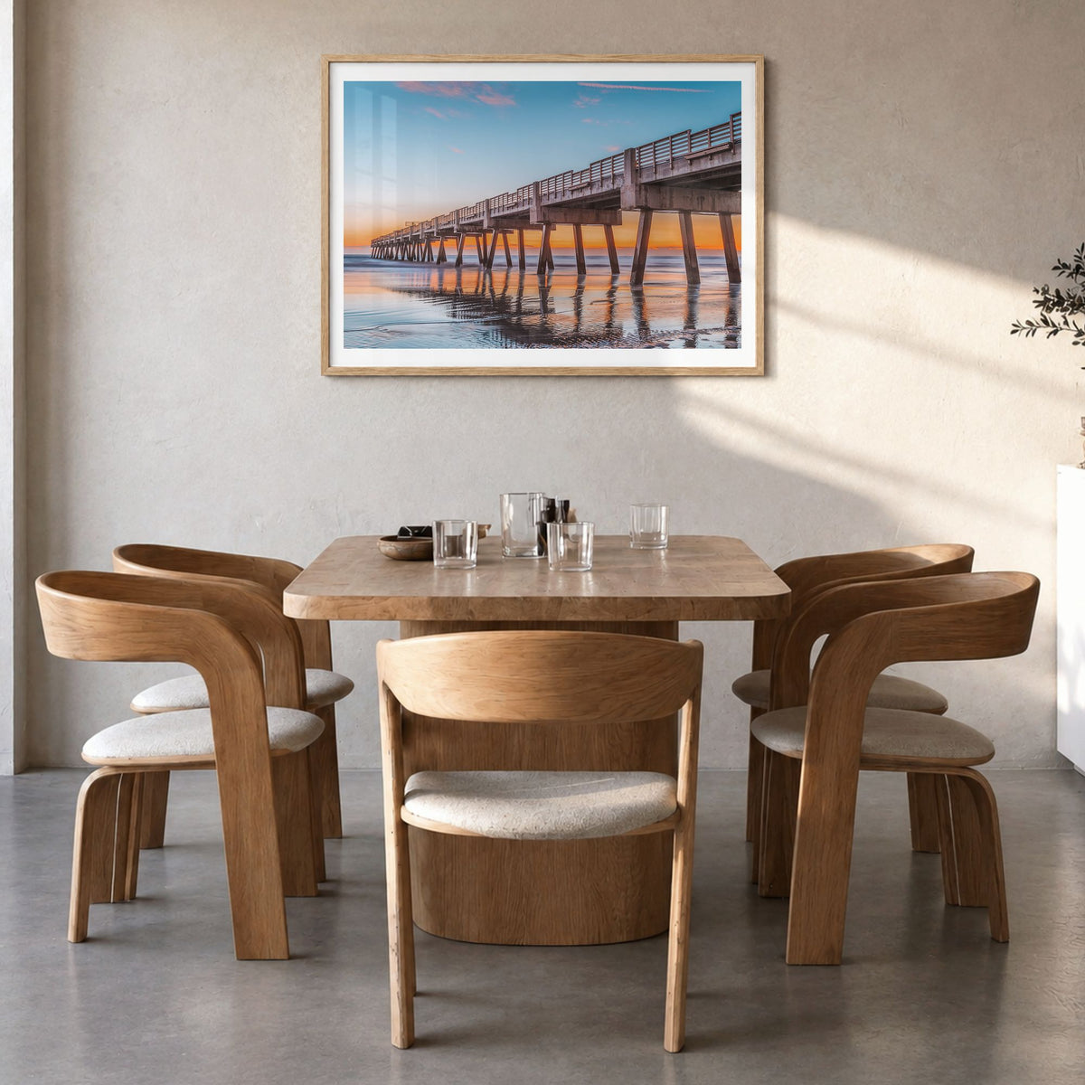 Jacksonville Beach Photo Poster in a natural wood frame, hanging in a dining room, white border