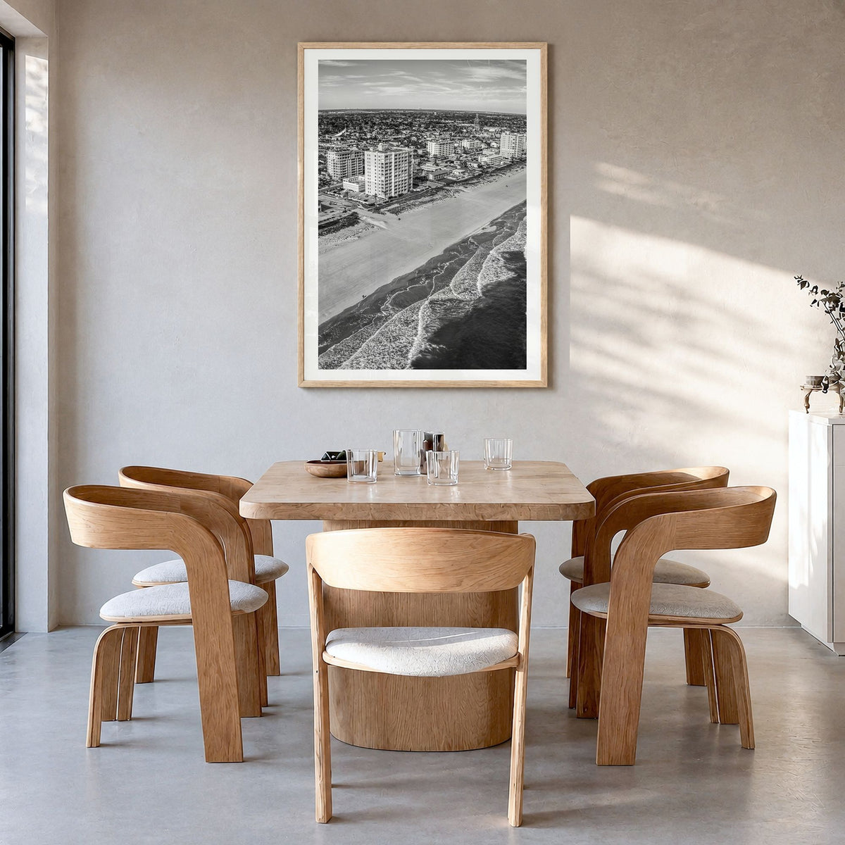 Jacksonville Beach Photo Poster in a natural wood frame, hanging in a dining room, white border