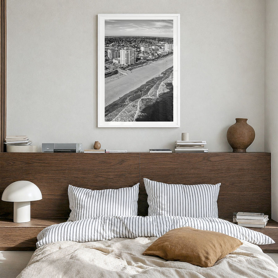 Jacksonville Beach Photo Poster in a white wood frame, hanging in a bedroom, white border