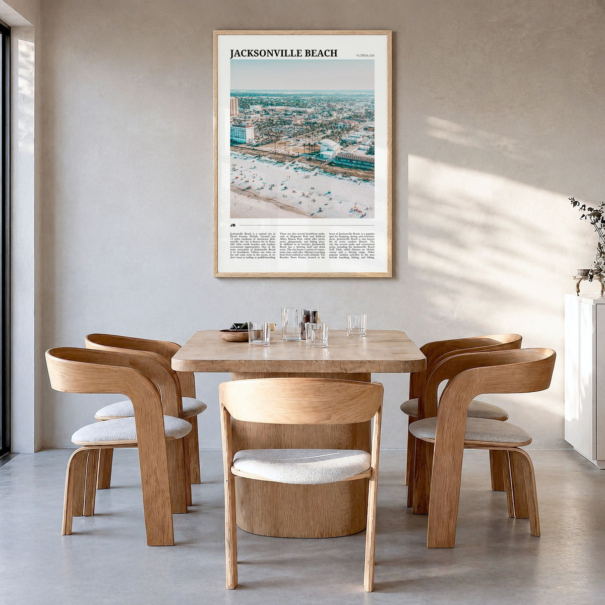 Jacksonville Beach Travel Poster in a natural wood frame, hanging in a dining room