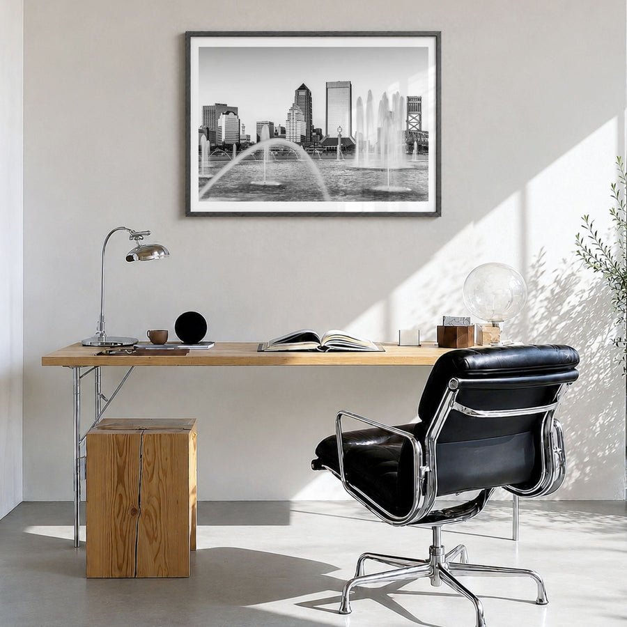 Jacksonville Photo Poster in a black wood frame, hanging in a bright home office, white border
