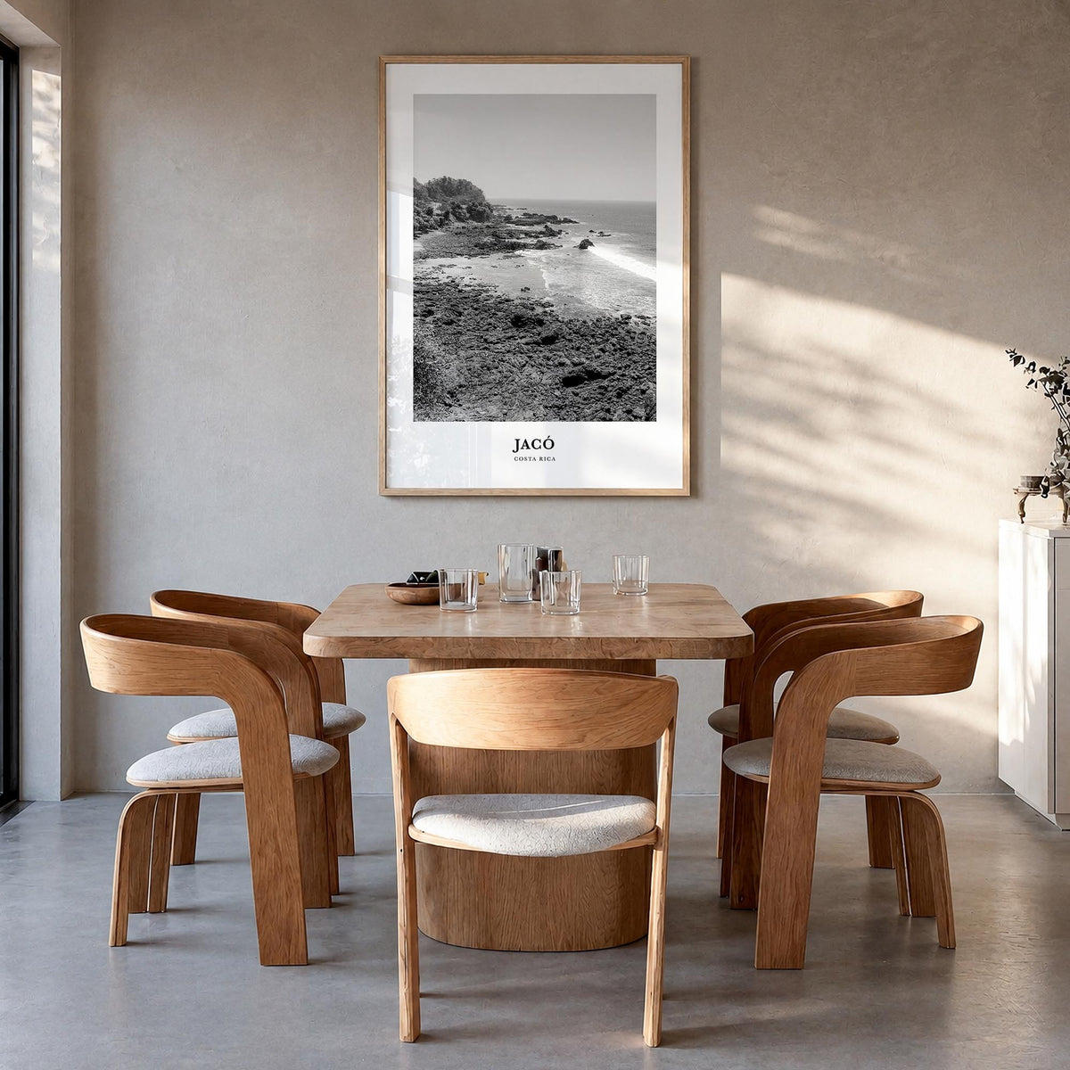 Jacó black & white classic poster of Costa Rica – vertical wall art in natural wood frame, hanging on wall